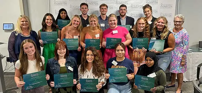 Group of happy alumni at a research foundation event.