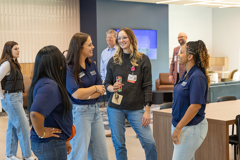 new student chatting with student ambassadors at an event.