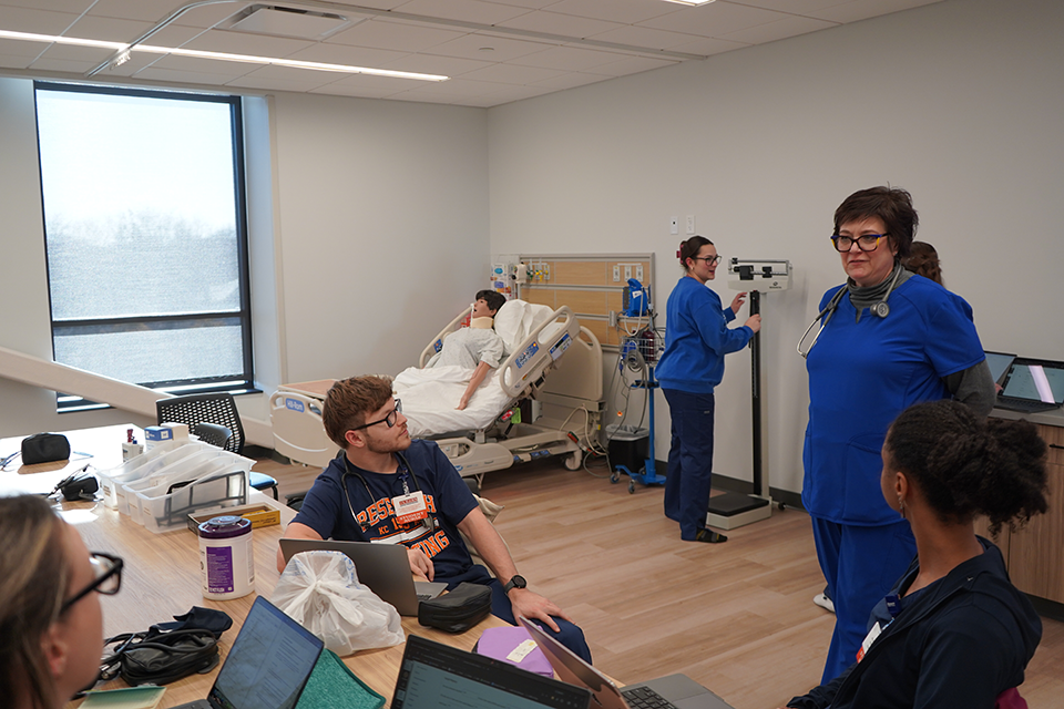 Wide view of simulation suite being used by a professor to teach class.