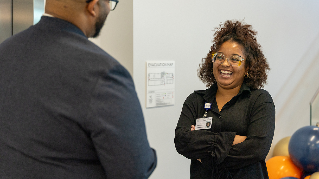 Admissions staff laughing together in conversation.