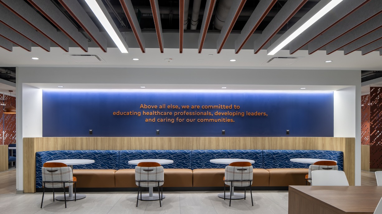 Navy wall with orange writing of RCoN mission.